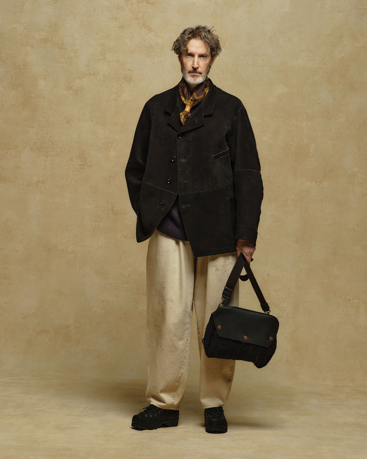 A model wearing AUBERGE's french work trousers 'BEZIERS' in Natural, showcasing the curved barrel silhouette.